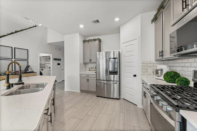 a kitchen with refrigerator and cabinets