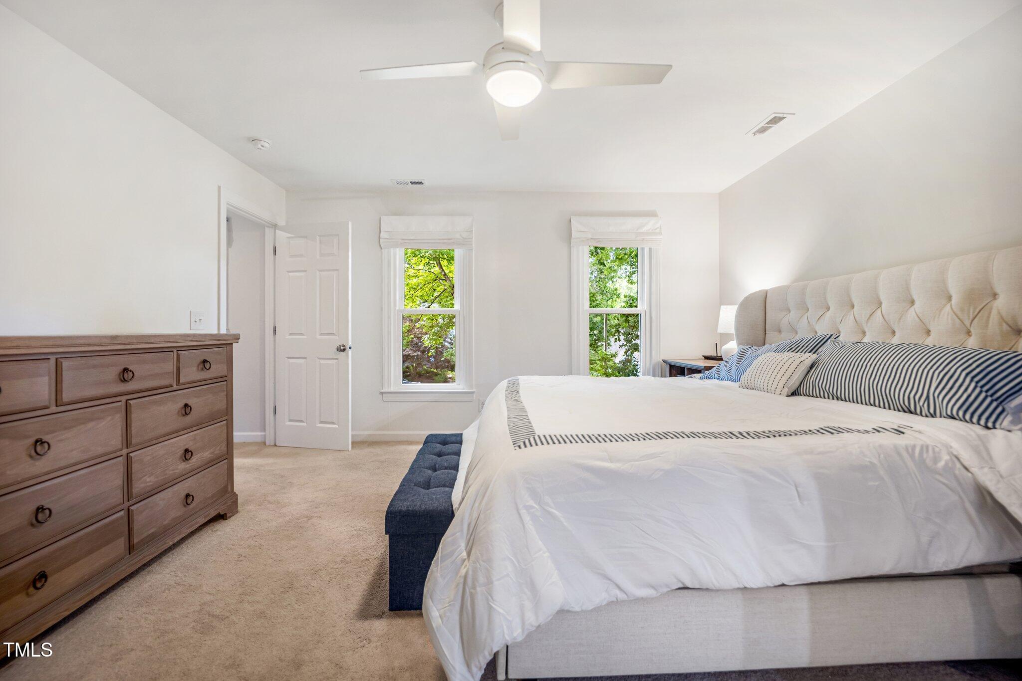 2409 Basil Drive Raleigh, NC 27612 - Photo 22 of 44 a large white bed in a bedroom and window