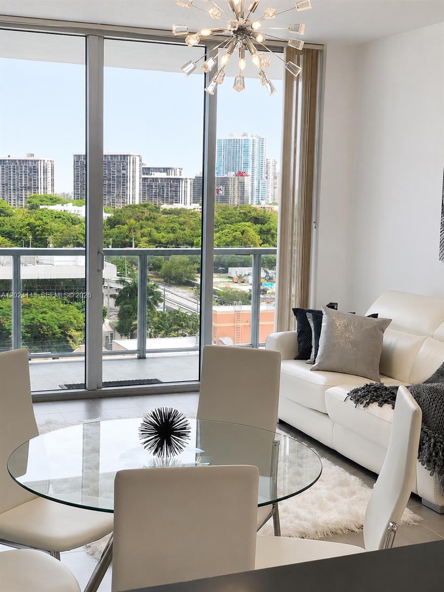 79 Southwest 12th Street, Unit 1405S Miami, FL 33130 - Photo 2 of 7 a living room with furniture and a large window