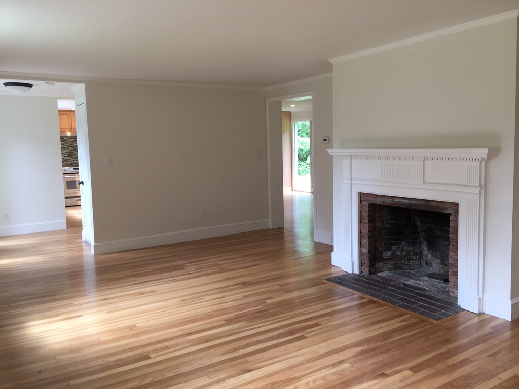 7 Chapman Road Boxford, MA 01921 - Photo 12 of 22 a view of a livingroom with wooden floor and a fireplace