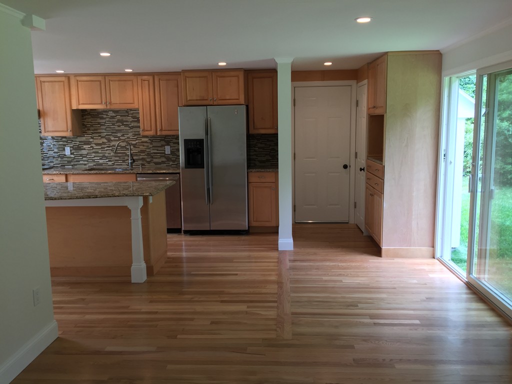 7 Chapman Road Boxford, MA 01921 - Photo 9 of 22 a kitchen with stainless steel appliances granite countertop a refrigerator and a sink