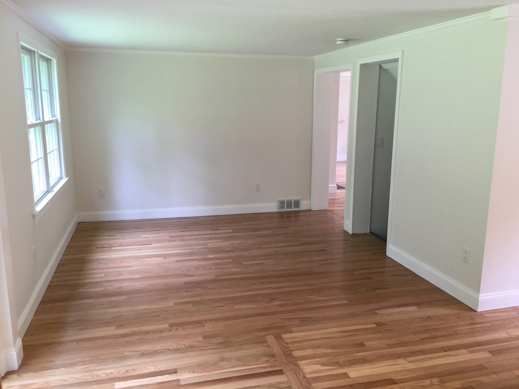 7 Chapman Road Boxford, MA 01921 - Photo 10 of 22 an empty room with wooden floor and windows