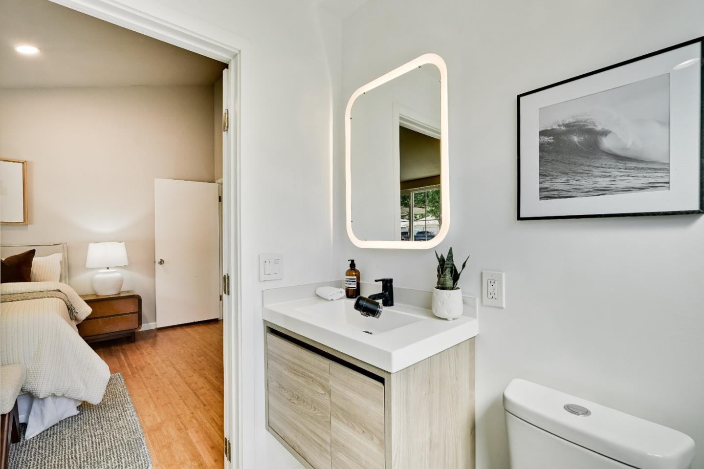 1755 Ravizza Avenue Santa Clara, CA 95051 - Photo 21 of 36 a en suite bathroom with a toilet sink and mirror