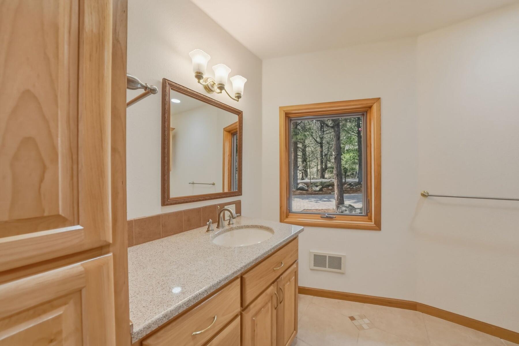 637 Northwest Silver Buckle Road Bend, OR 97703 - Photo 23 of 68 a bathroom with a sink and a mirror