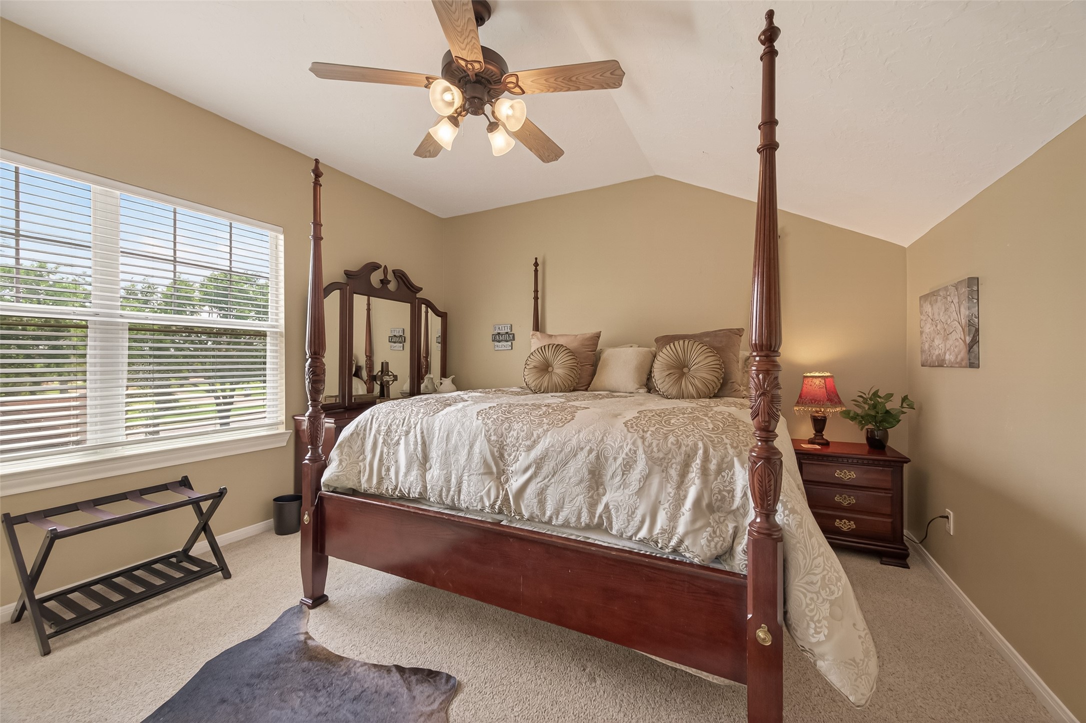 2319 Braer Ridge Drive Katy, TX 77494 - Photo 35 of 50 a spacious bedroom with a bed a chandelier and a window