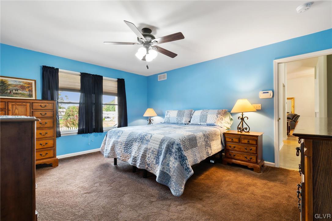 1206 Shiloh Road Allentown, PA 18106 - Photo 18 of 28 a spacious bedroom with a bed and a chandelier