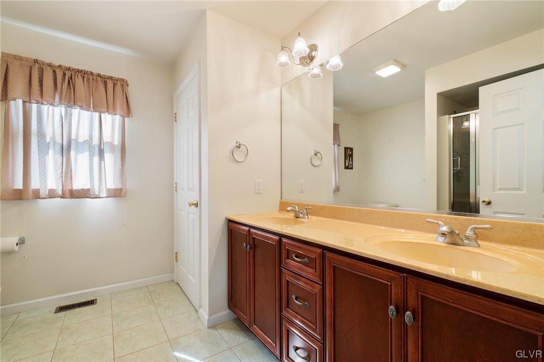 1206 Shiloh Road Allentown, PA 18106 - Photo 20 of 28 a bathroom with a double vanity sink and a mirror