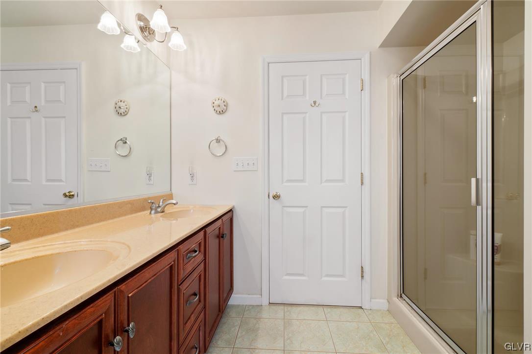 1206 Shiloh Road Allentown, PA 18106 - Photo 21 of 28 a bathroom with a granite countertop sink a mirror and a bathtub