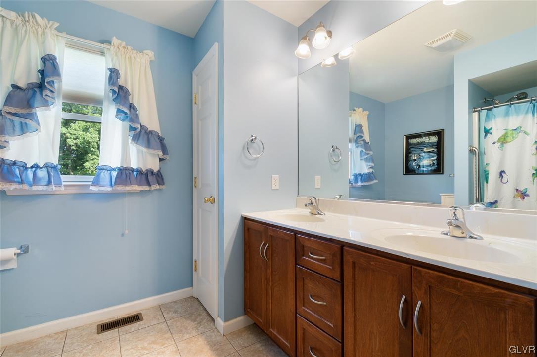 1206 Shiloh Road Allentown, PA 18106 - Photo 24 of 28 a bathroom with a double vanity sink and a mirror