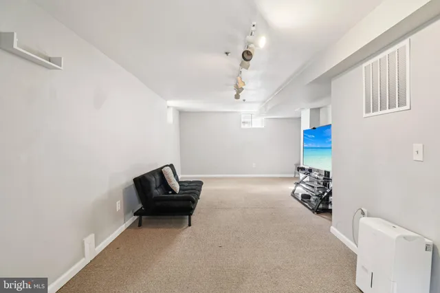 a living room with furniture chess board and a couch