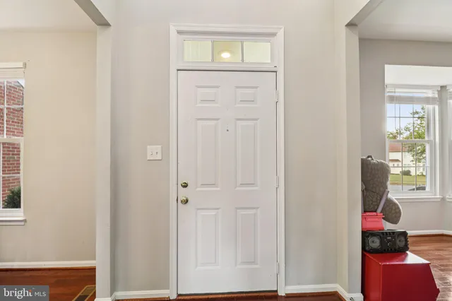 an entryway with wooden floor and closet