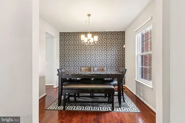 a kitchen with a stove a sink and white cabinets