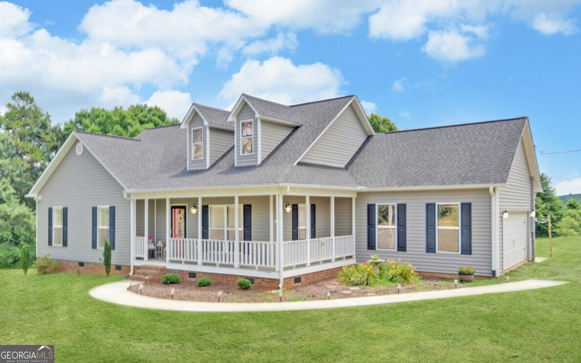 a view of a house with a yard table and chairs