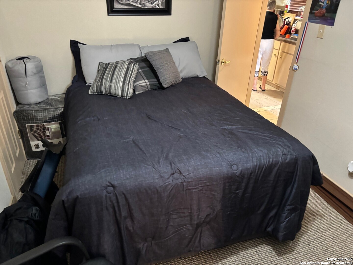 952 Madrona Road Pipe Creek, TX 78063 - Photo 13 of 33 a bed sitting in a bedroom next to a window