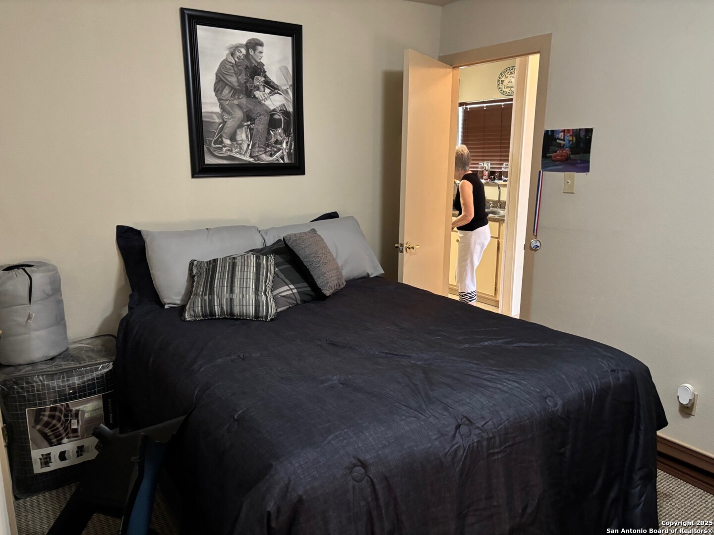 952 Madrona Road Pipe Creek, TX 78063 - Photo 14 of 33 a bedroom with a bed and wooden floor