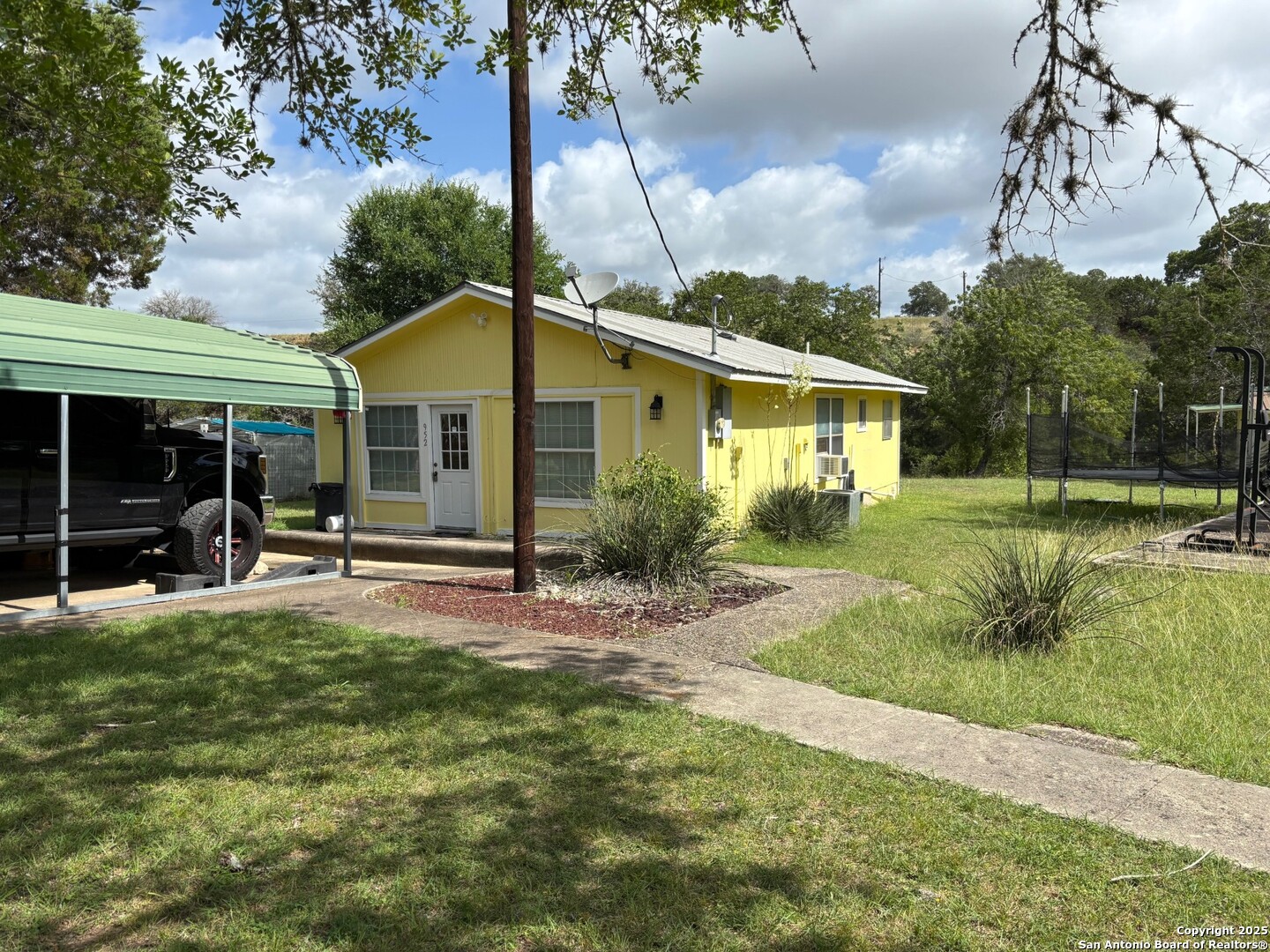952 Madrona Road Pipe Creek, TX 78063 - Photo 2 of 33 a view of a house with backyard and porch