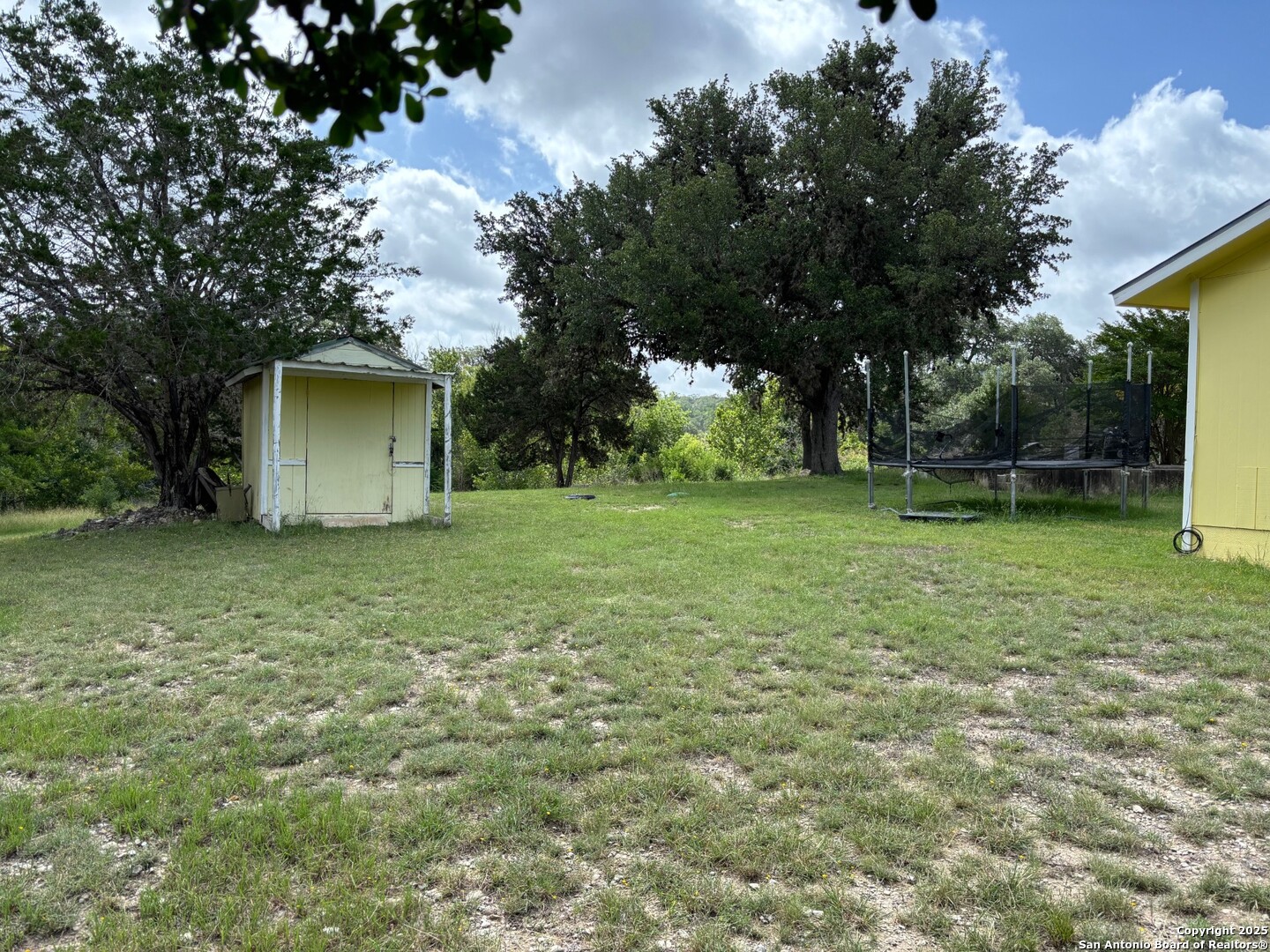 952 Madrona Road Pipe Creek, TX 78063 - Photo 25 of 33 a backyard of a house with lots of green space