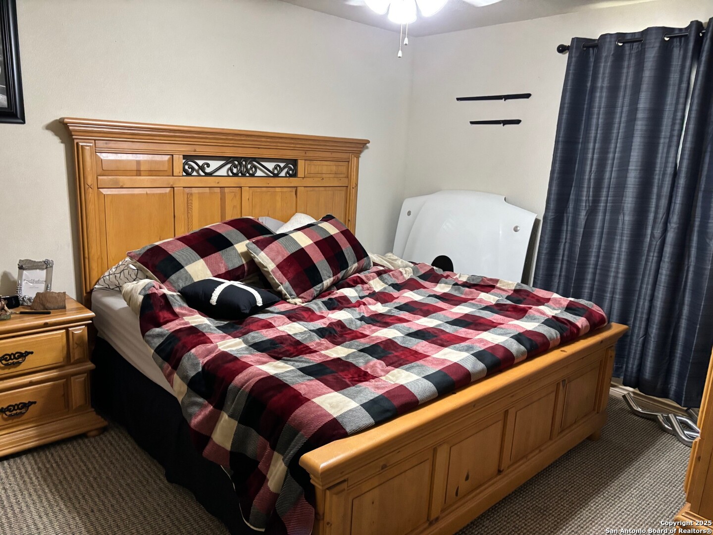 952 Madrona Road Pipe Creek, TX 78063 - Photo 10 of 33 a bedroom with a bed and window