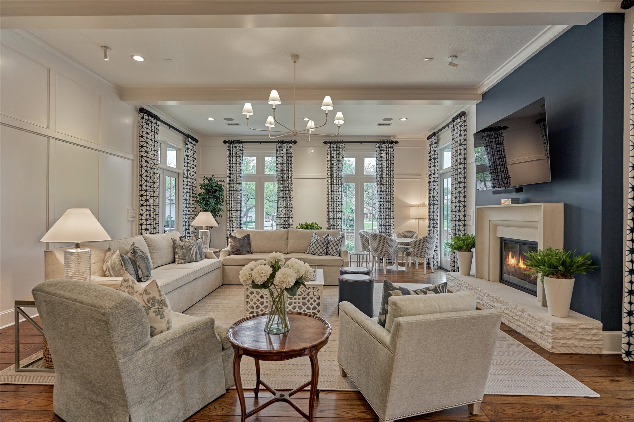 22 East Shore Drive The Woodlands, TX 77380 - Photo 16 of 50 The updated Family Room has custom drapery, paneled walls, refaced fireplace with glass doors, gas logs and remote start, extensive Sonos Sound System with Amplifiers (1st floor, outdoor 1st floor porches front/back and game room).