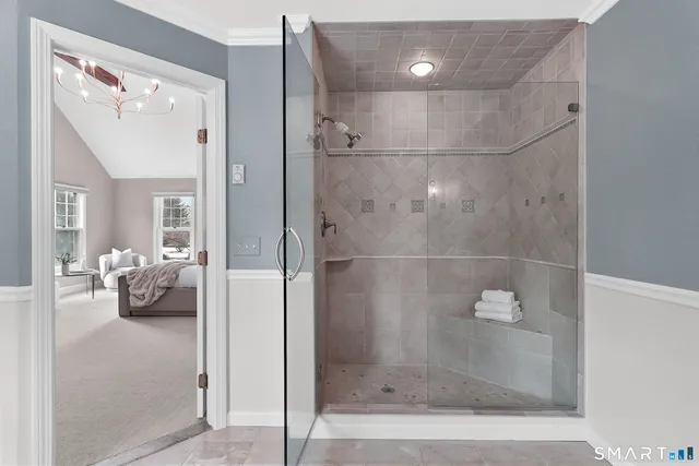 a bathroom with a glass shower door and a sink