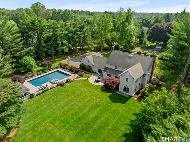 an aerial view of a house with backyard