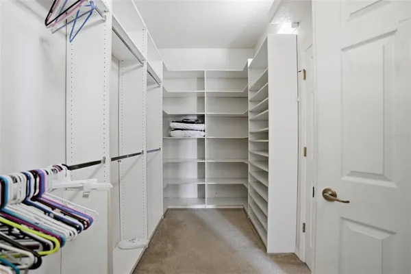 a view of walk in closet with empty racks