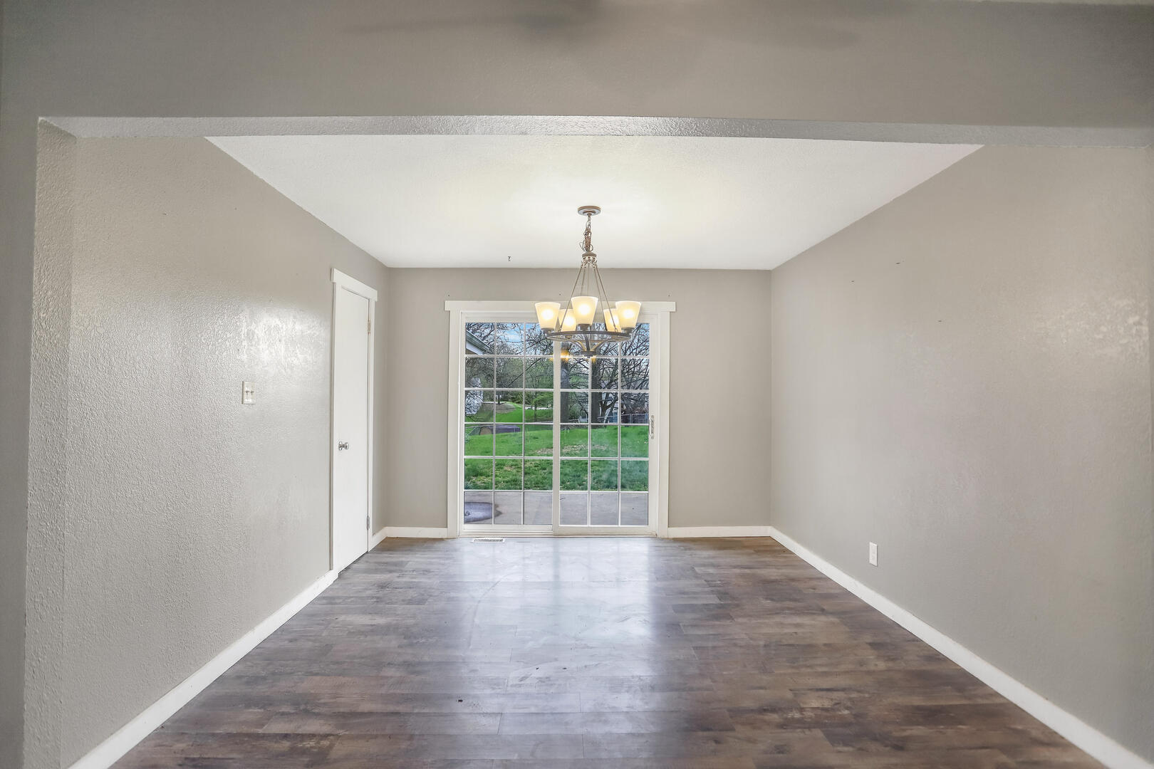 2380 Windsor Road Decatur, IL 62521 - Photo 9 of 27 wooden floor in an empty room with a window