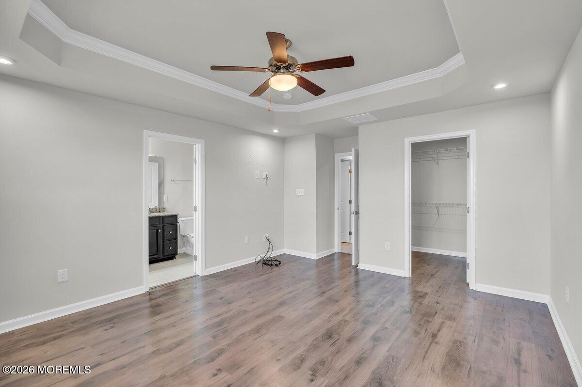411 Sammy Street Swedesboro, NJ 08085 - Photo 15 of 24 a view of an empty room with wooden floor and a ceiling fan