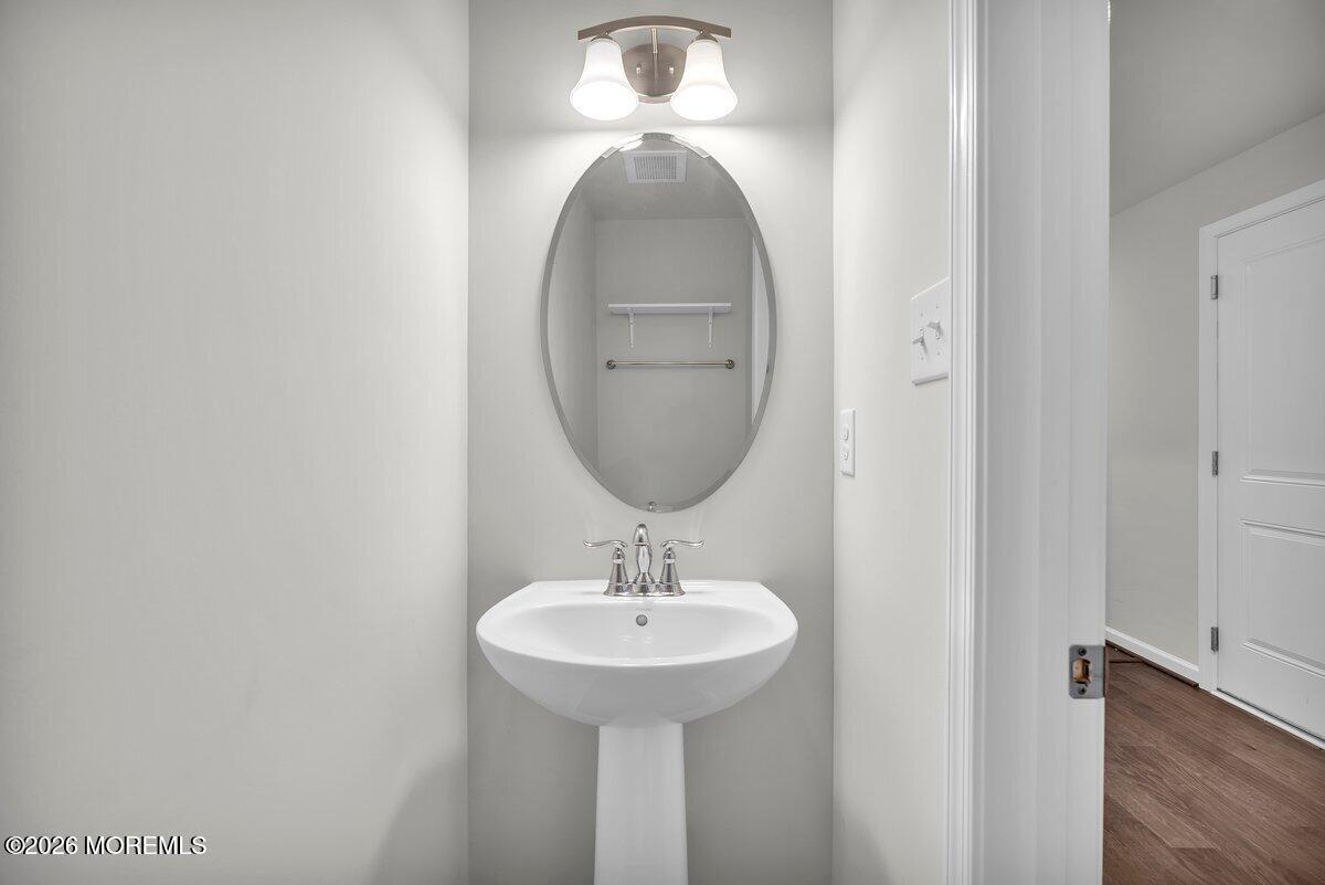 411 Sammy Street Swedesboro, NJ 08085 - Photo 3 of 24 a bathroom with a sink and a mirror