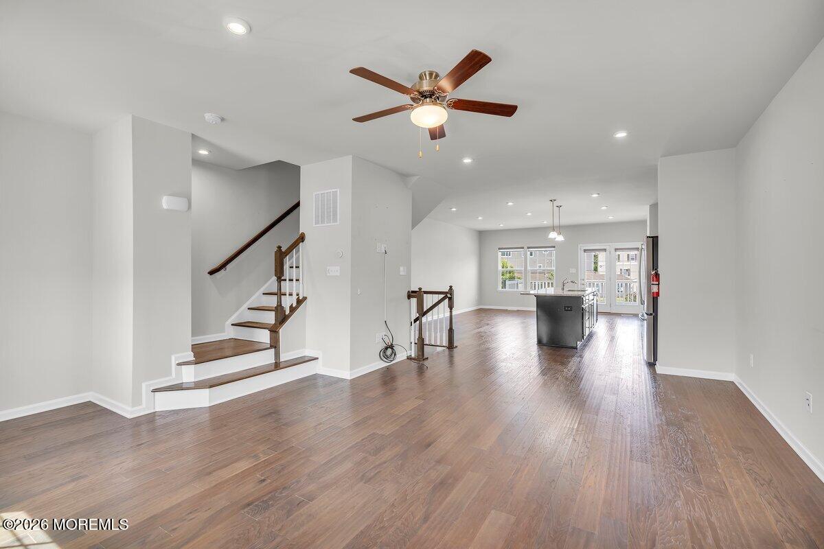 411 Sammy Street Swedesboro, NJ 08085 - Photo 6 of 24 a view of an empty room with wooden floor and a ceiling fan