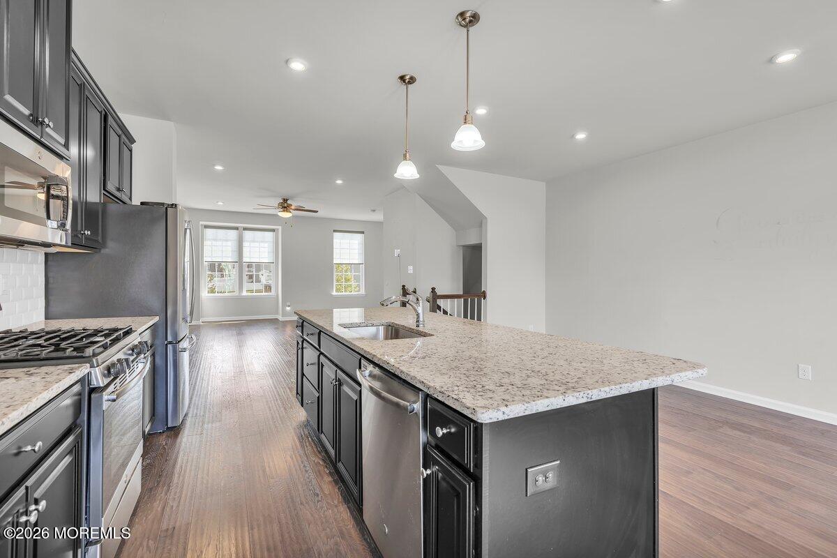 411 Sammy Street Swedesboro, NJ 08085 - Photo 8 of 24 a kitchen with a stove and a wooden floor