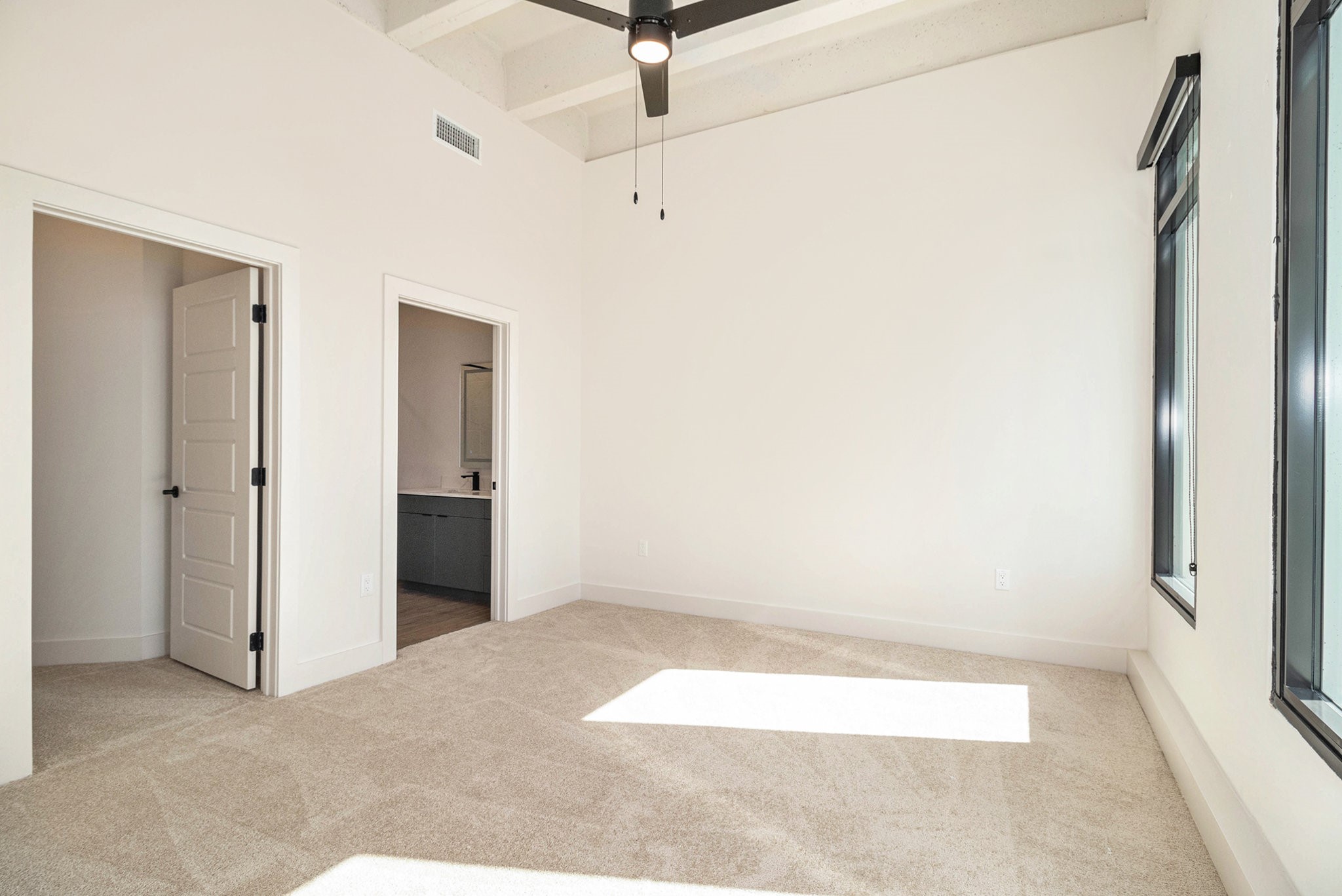 1801 Smith Street, Unit 1814 Houston, TX 77002 - Photo 3 of 24 a view of a room with wooden floor and white walls