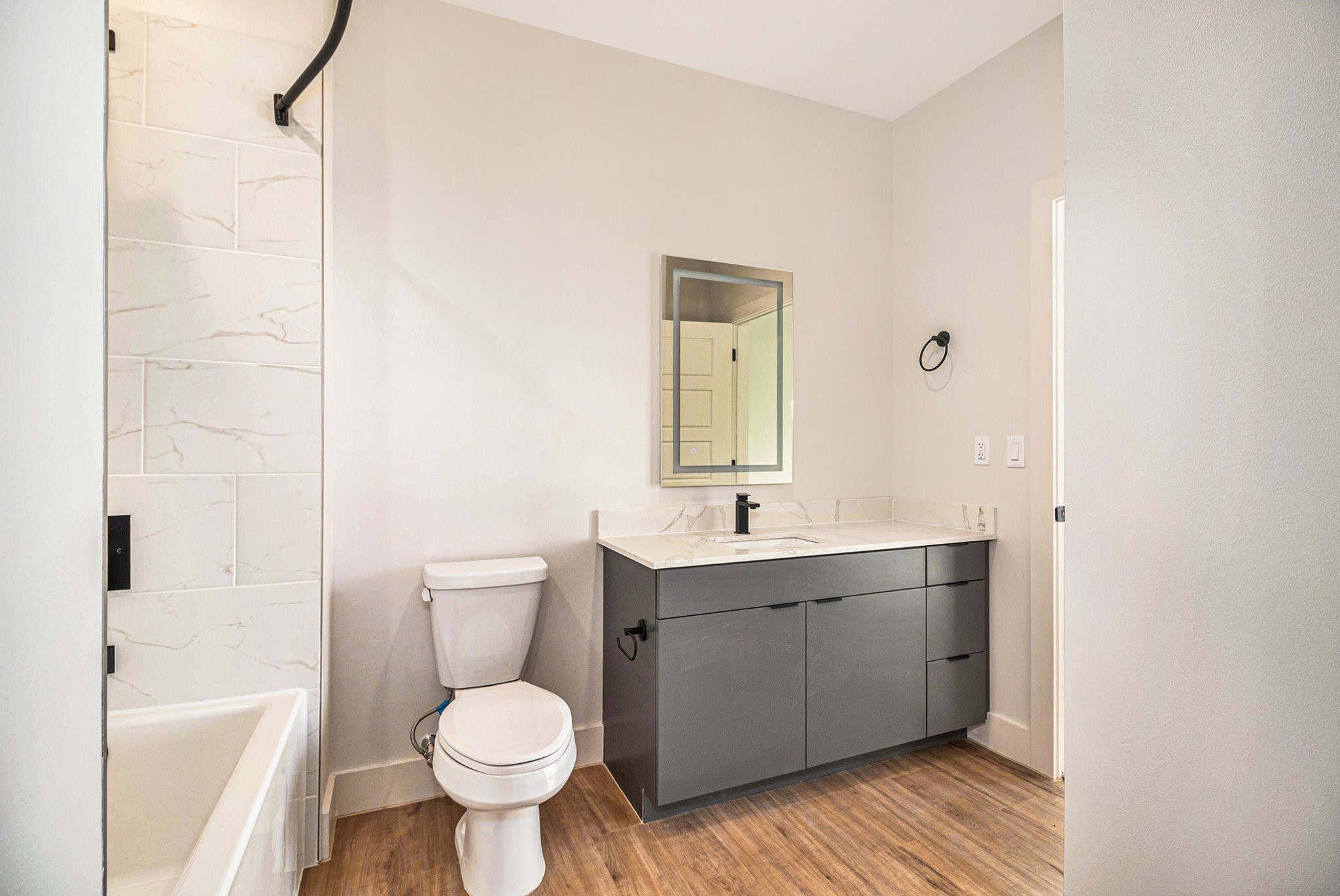 1801 Smith Street, Unit 1814 Houston, TX 77002 - Photo 5 of 24 a bathroom with a toilet sink and mirror
