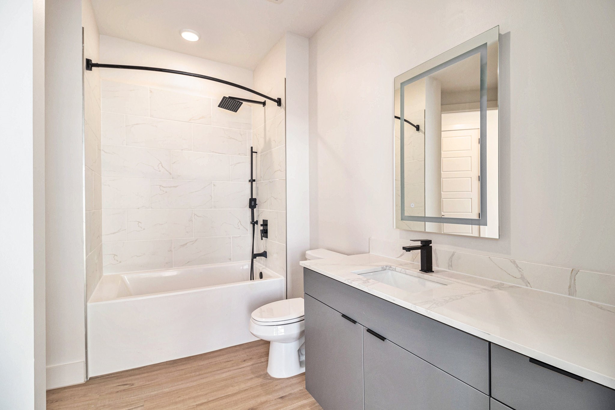 1801 Smith Street, Unit 1814 Houston, TX 77002 - Photo 6 of 24 a bathroom with a sink toilet and shower