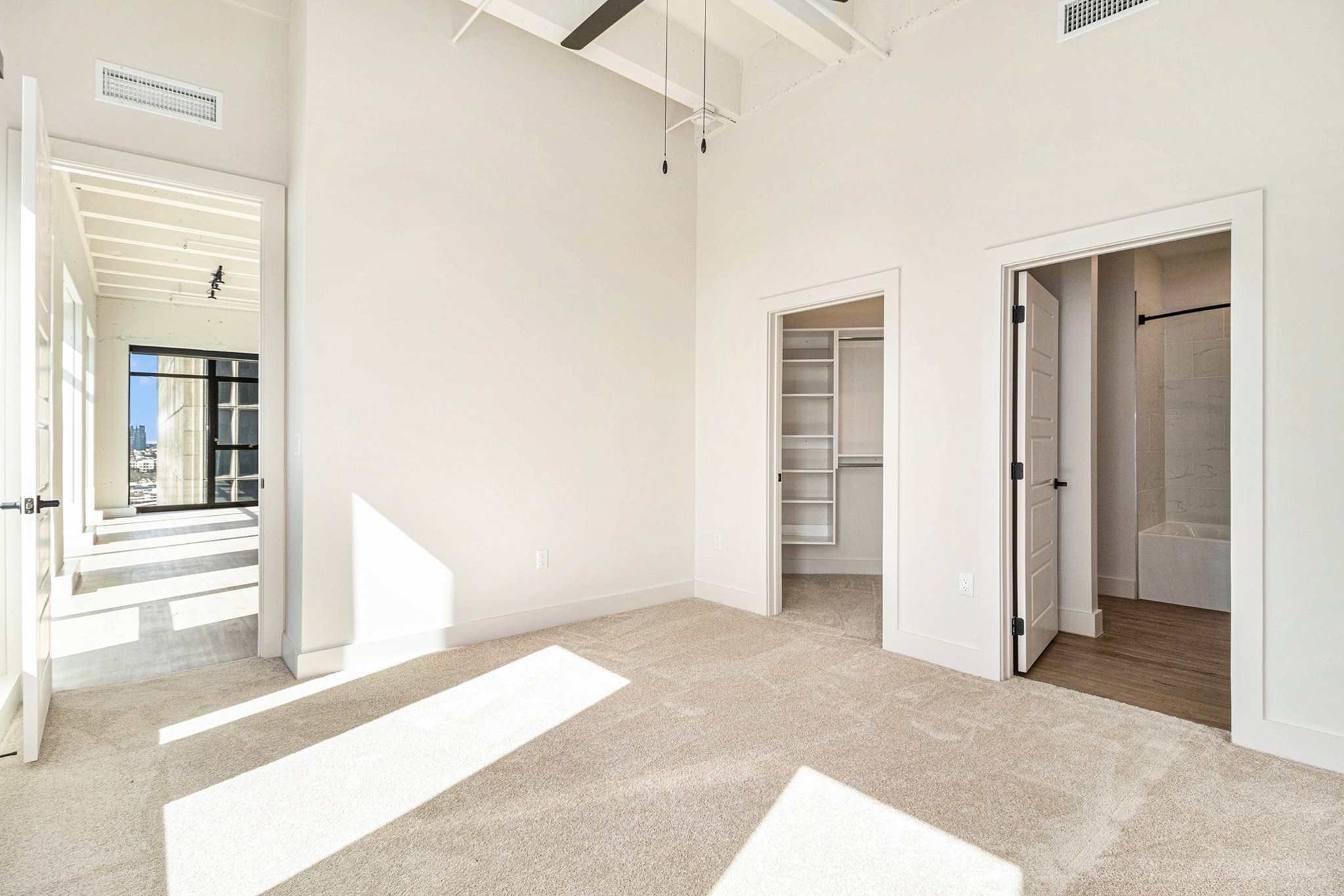 1801 Smith Street, Unit 1814 Houston, TX 77002 - Photo 7 of 24 a view of a livingroom with wooden floor and a bathroom