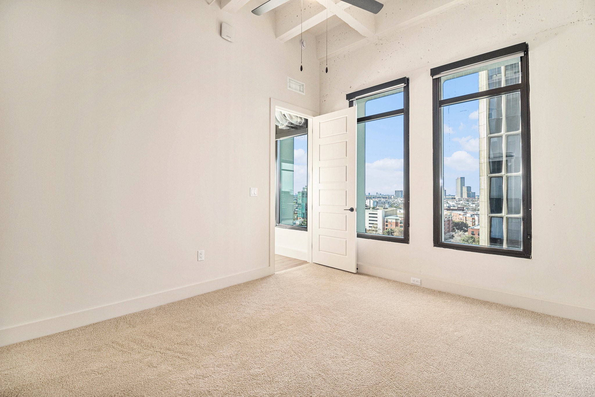 1801 Smith Street, Unit 1814 Houston, TX 77002 - Photo 9 of 24 an empty room with windows