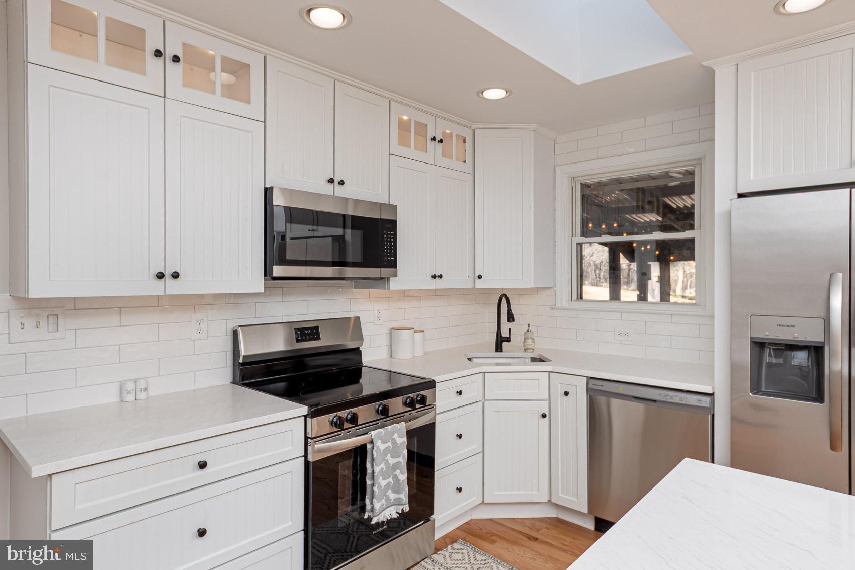 2308 Carlo Road Fallston, MD 21047 - Photo 3 of 53 a kitchen with white cabinets and black appliances