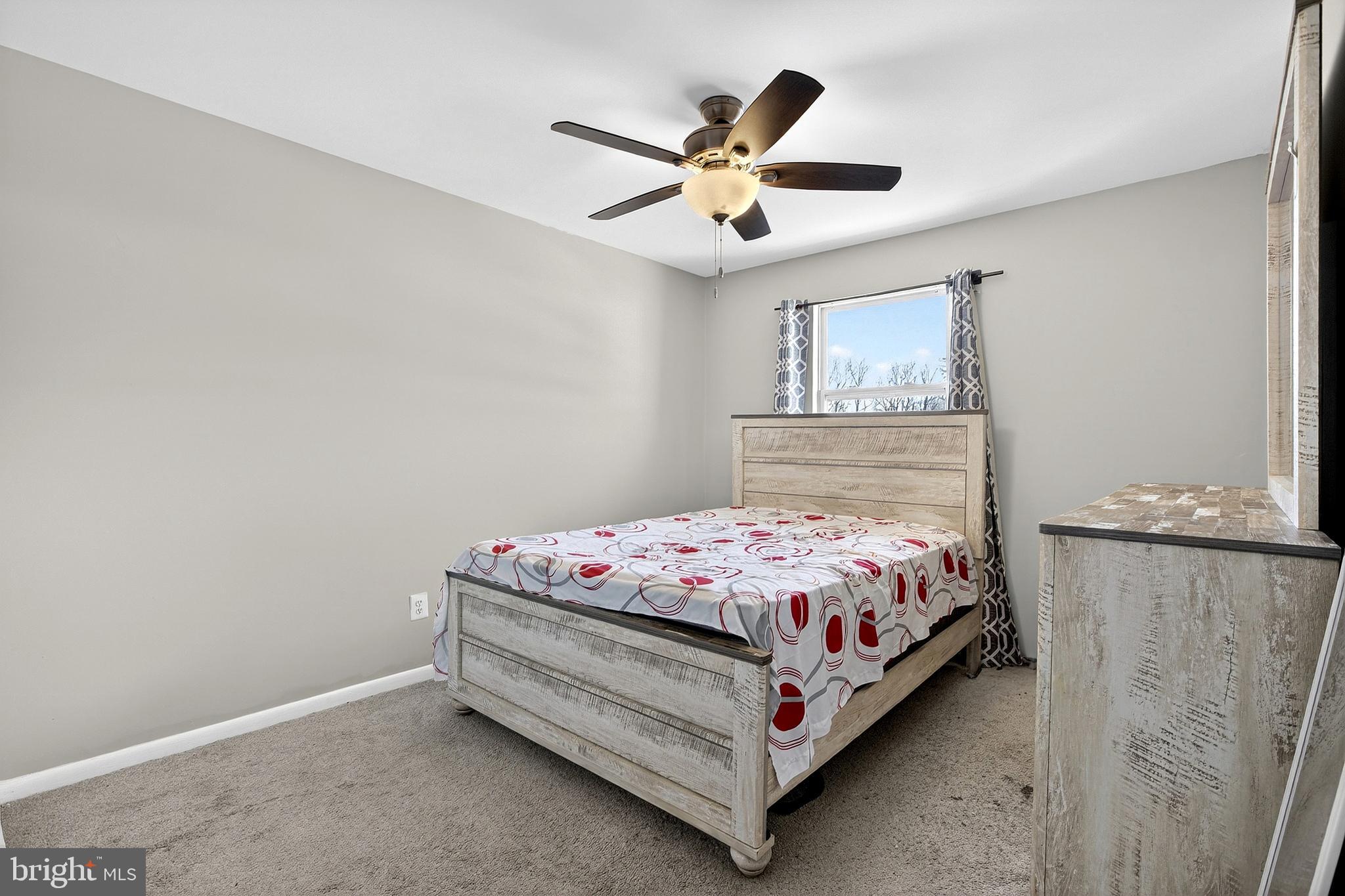 7 Gull Turn Newark, DE 19702 - Photo 22 of 29 a bedroom with a bed and a chandelier