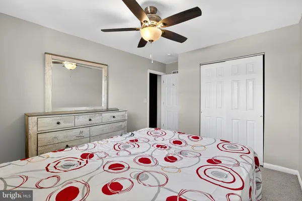 a bedroom with a bed and a dresser