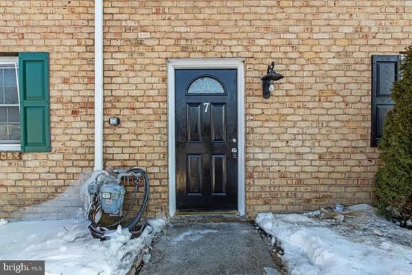 a view of a wooden door and brick wall