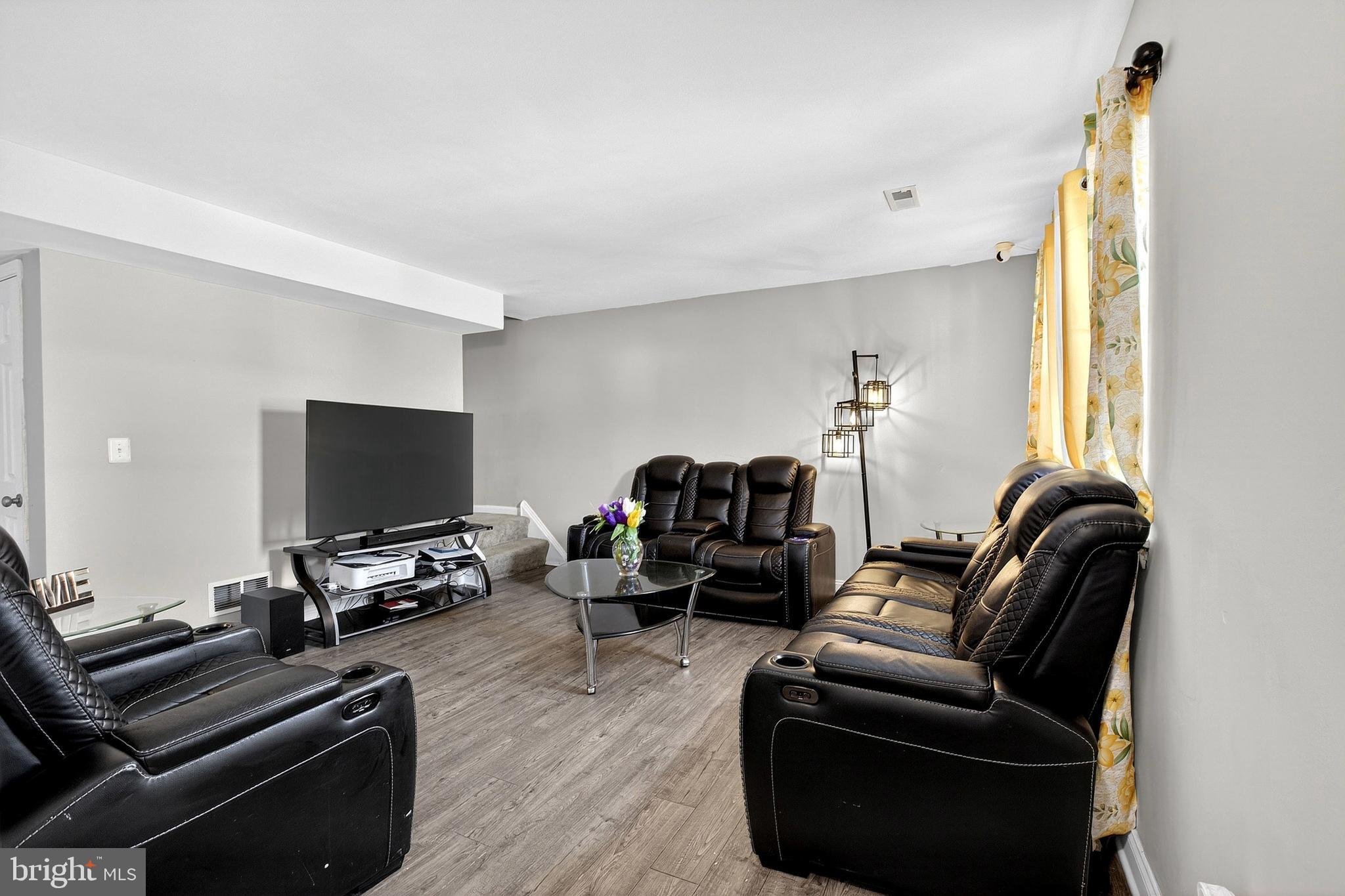 7 Gull Turn Newark, DE 19702 - Photo 6 of 29 a living room with furniture a flat screen tv and a window