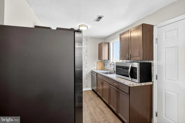 a kitchen with stainless steel appliances a refrigerator and a stove