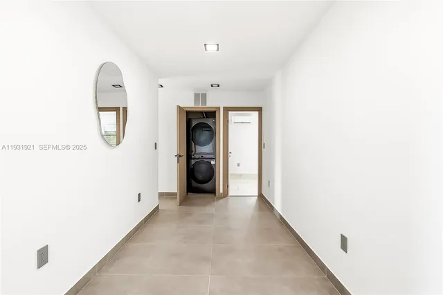 a view of a hallway to a livingroom with wooden floor