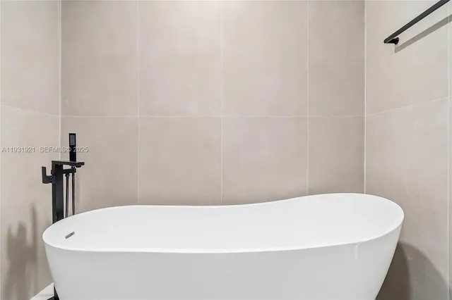 a white tub sitting in a bathroom