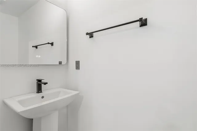 a bathroom with a sink a mirror and a shower