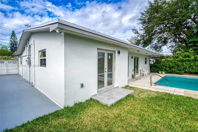 a front view of house with yard and green space