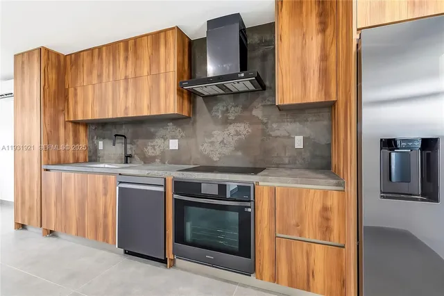 a kitchen with granite countertop wooden cabinets and a stove top oven