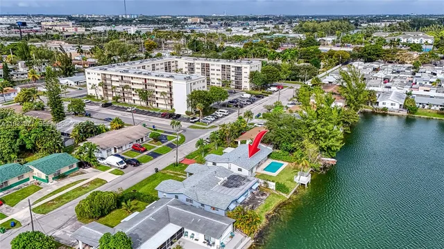 an aerial view of residential houses with outdoor space and lake view