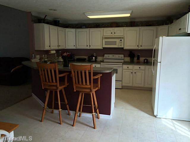 1100 Woodbury Road King, NC 27021 - Photo 3 of 12 Kitchen. Lots of cabinets and counter space in this open airy kitchen.