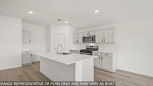 a kitchen with stainless steel appliances a sink stove and refrigerator